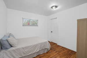 Bedroom with dark wood finished floors