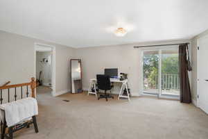 Office area featuring baseboards and light colored carpet