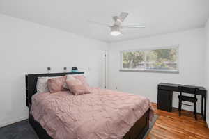 Bedroom with baseboards, a ceiling fan, and light wood-style floors