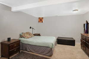 Bedroom with baseboards and light colored carpet