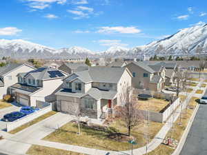 Exterior space with a mountain view, fence, driveway, a residential view, and stucco siding