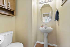 Bathroom featuring toilet and baseboards