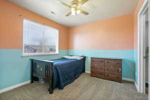 Bedroom featuring a ceiling fan, light colored carpet, visible vents, and baseboards