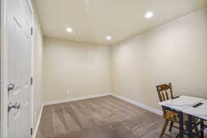 Carpeted office with baseboards, visible vents, and recessed lighting