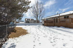 Snowy yard with fence