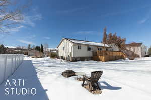 Exterior space with an outdoor fire pit, a wooden deck, and central AC unit