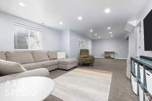 Living room featuring baseboards, carpet, and recessed lighting