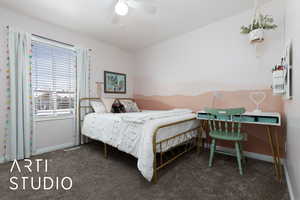 Bedroom with ceiling fan, baseboards, and dark colored carpet