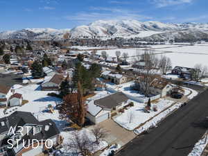 Snowy aerial view with a residential view and a mountain view