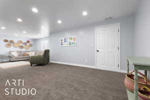 Living area featuring baseboards, visible vents, carpet flooring, and recessed lighting