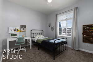 Bedroom featuring ceiling fan, carpet floors, and baseboards