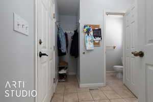 Bathroom with baseboards, toilet, visible vents, and tile patterned floors