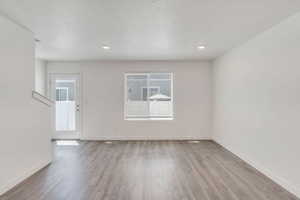 Spare room with light wood-style flooring and baseboards