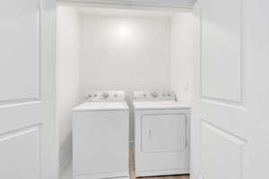 Washroom with laundry area and washer and clothes dryer