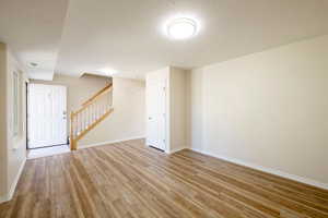 Nice sized Living room, with new window, new LVP flooring, freshly paint room and baseboards, new carpet on stairs.