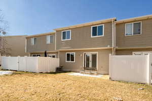 Rear view of house featuring lawn, concrete patio. New owner may also fence in the patio area if so desired.