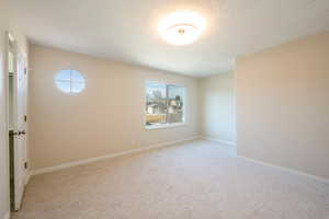 View of the same main bedroom, with en-suite bath. Newly painted bedroom, baseboards, new windows and new light colored carpet This main bedroom features, en-suite bathroom, a walk-in closet with plenty of hanging space and shelving