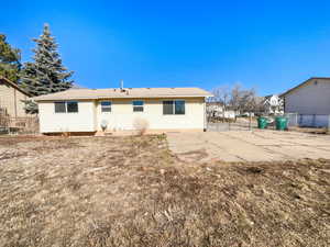 Rear view of house with fence and a patio area
