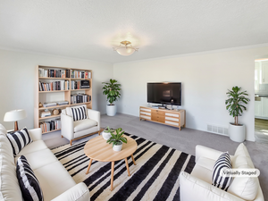 Living room with ornamental molding, visible vents, a textured ceiling, and carpet floors