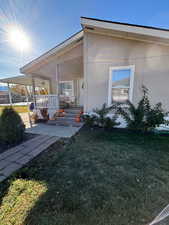 Exterior space featuring covered porch and a lawn