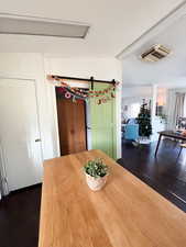 Unfurnished dining area with visible vents and dark wood finished floors