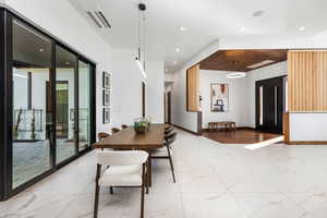 Dining area with recessed lighting, marble finish floor, visible vents, and baseboards