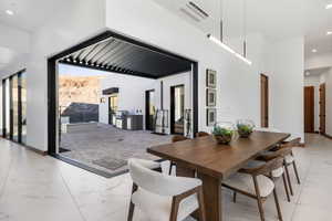 Dining space featuring baseboards, marble finish floor, visible vents, and recessed lighting