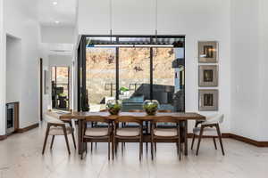 Dining space with marble finish floor and baseboards