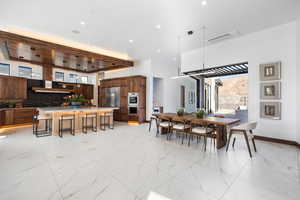 Dining area featuring marble finish floor, visible vents, baseboards, and recessed lighting