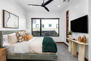 Carpeted bedroom with baseboards, visible vents, ceiling fan, a fireplace, and recessed lighting