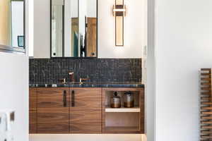 Bathroom with backsplash and vanity