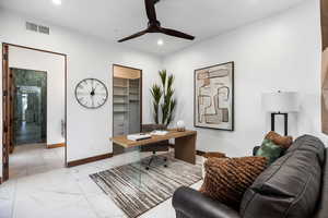 Office space featuring visible vents, baseboards, ceiling fan, marble finish floor, and recessed lighting