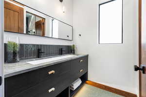 Bathroom featuring double vanity and a sink