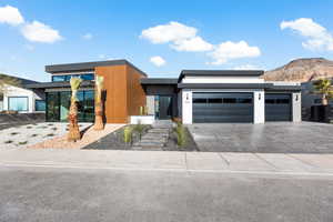 Contemporary house with a mountain view, driveway, and an attached garage