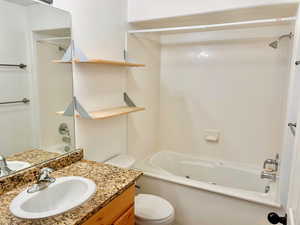 Bathroom featuring vanity, shower / tub combination, and toilet