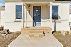 Property entrance featuring stucco siding