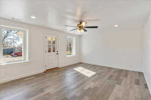 Entryway with light wood-style flooring, visible vents, baseboards, and recessed lighting