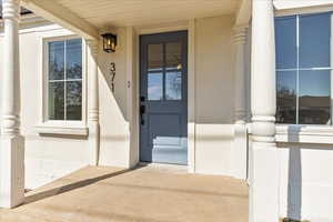 Entrance to property featuring stucco siding