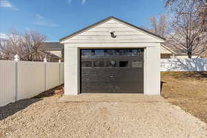 Detached garage with driveway and fence