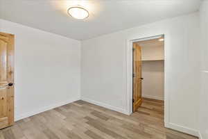 Unfurnished room with baseboards and light wood-style floors