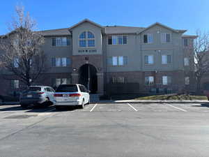 View of building exterior featuring uncovered parking