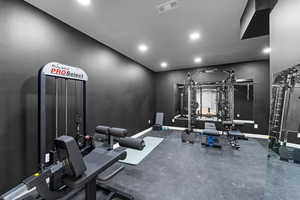 Workout area with recessed lighting, visible vents, and baseboards