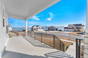 Balcony with a residential view and a water and mountain view