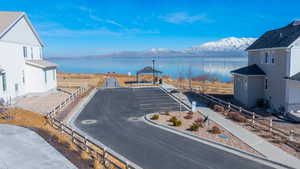 Water view with a gazebo, fence, and a mountain view