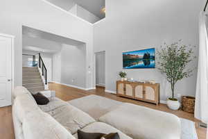 Living room featuring stairway and wood finished floors