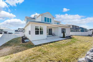 Back of property with a lawn, a patio area, and a fenced backyard