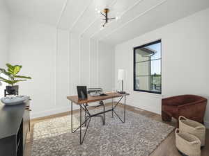 Office space featuring visible vents, baseboards, and wood finished floors