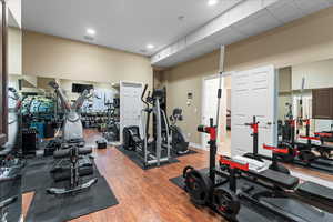 Exercise room featuring wood finished floors and baseboards
