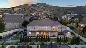 Rear view of house featuring a fenced backyard and a mountain view