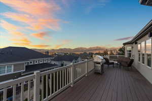 Deck at dusk with a residential view, outdoor lounge area, and a mountain view